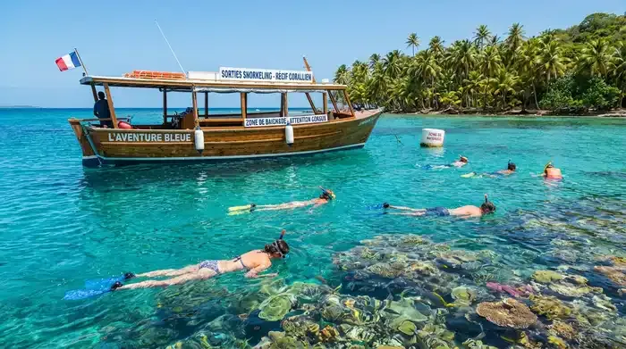 Snorkeling boat anchored in turquoise Caribbean water with coral reef visible